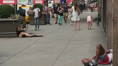 Homeless men laying down sleeping on a city street in New York City in 2021 Stock-Footage 158689257