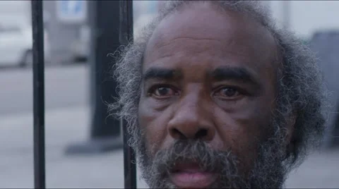 Homeless old man looking in the camera: poor man, beggar man, asking for charity Stock Footage