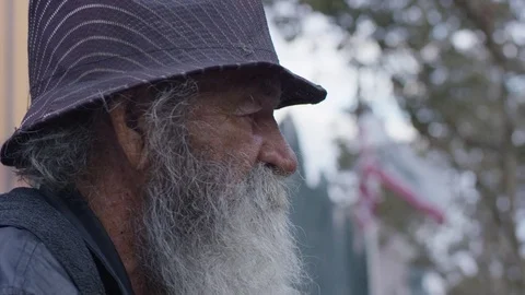 Homeless old man looking in the camera: poor man, beggar man, asking for charity Stock Footage 82870802