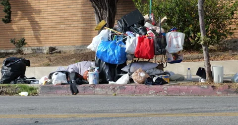 A homeless persons possessions at a bus stop Stock Footage 143947209