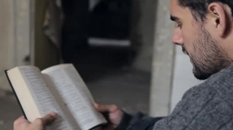 Homeless Reading the Bible Stock Footage 56565893
