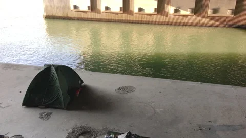 Homeless by the river one tente Stock Footage 172117839