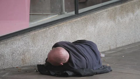 A homeless rough sleeper on the side of a pedestrian walk in London. Stock Footage 309155044