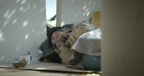 Homeless senior man lying down on the sidewalk Stock Footage 139847305