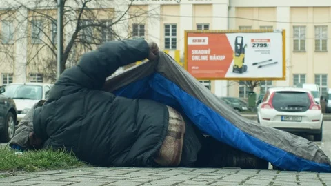 Homeless sleep authentic in sleeping bag on street emotion city Video stock 104898542