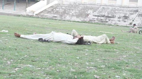 Homeless sleeping on the grass Stock Footage 29667831