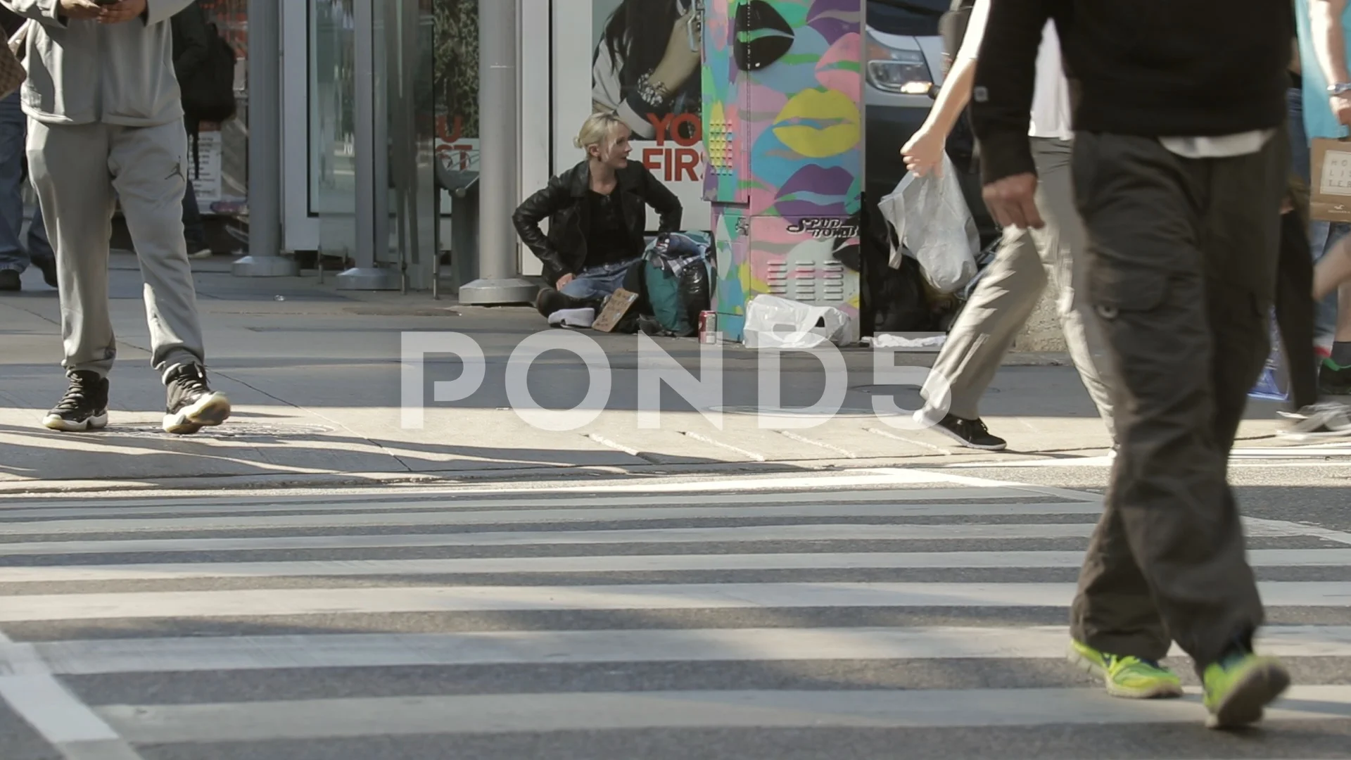 Homeless youth with possessions on downtown street