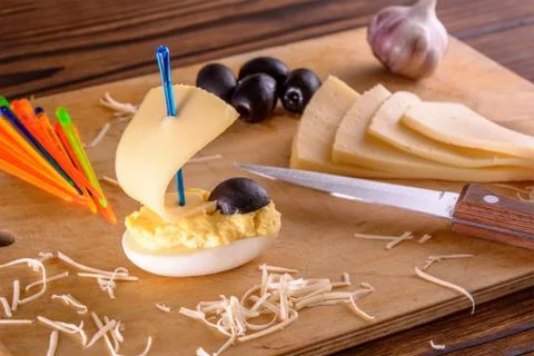 Homemade appetizer in the ship shape from egg and cheese Stock Photos