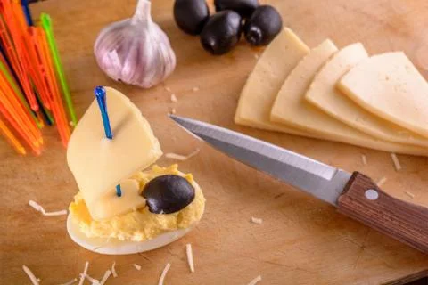 Homemade appetizer in the ship shape from egg and cheese. Closeup Stock Photos