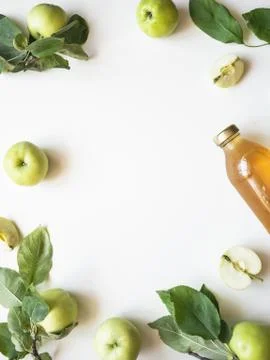 Homemade apple cider vinegar in glass bottle. Fermented apple juice and fresh Stock Photos