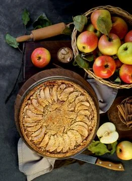 Homemade apple pie on dark rustic background, top view. Stock Photos