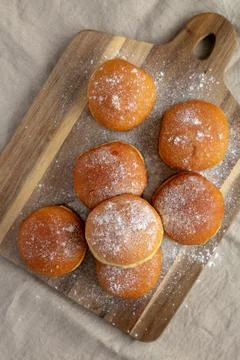 Homemade Apricot Polish Paczki Donut with Powdered Sugar on a Wooden Board,.. Stock Photos