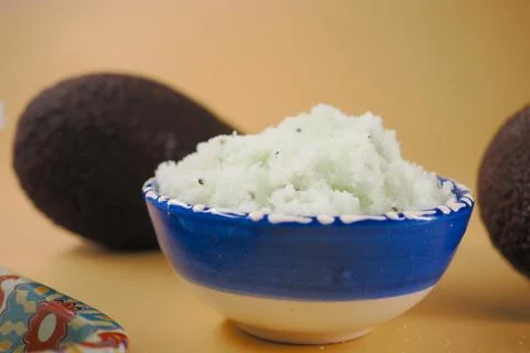 Homemade avocado scrub in a blue-patterned ceramic bowl Stock Photos
