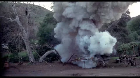 Homemade bomb exploding in shed in woods, 1970s 스톡 동영상 260259077
