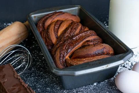 Homemade braid bread with a bottle of milk on the side and a piece of chocola Stock Photos