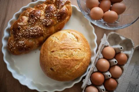 Homemade bread and eggs on rustic kitchen table Foto stock