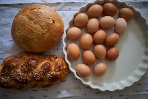 Homemade bread and eggs on rustic kitchen table Foto stock