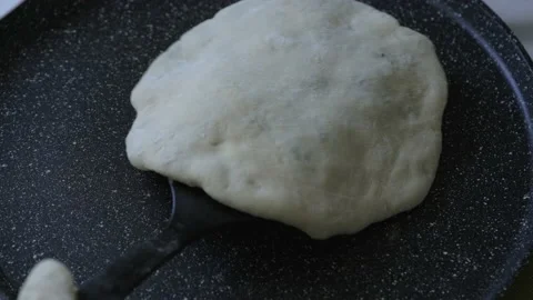 Homemade bread is cooked in a frying pan. Stock Footage 154940976