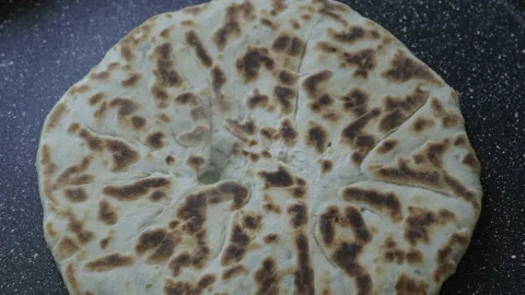 Homemade bread is cooked in a frying pan. Stock Footage 155186388