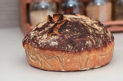 Homemade bread in the kitchen on a white table 2 Stock Photos