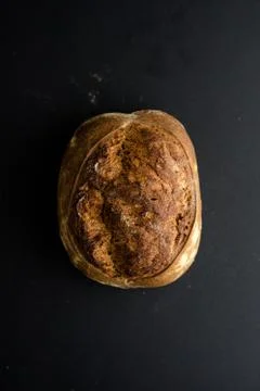 Homemade bread loaf on rustic dark background Stock Photos