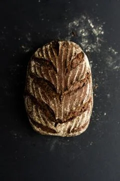 Homemade bread loaf on rustic dark background Stock Photos