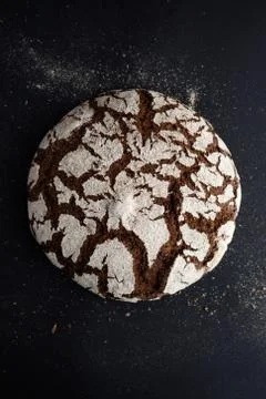 Homemade bread loaf on rustic dark background top view Stock Photos