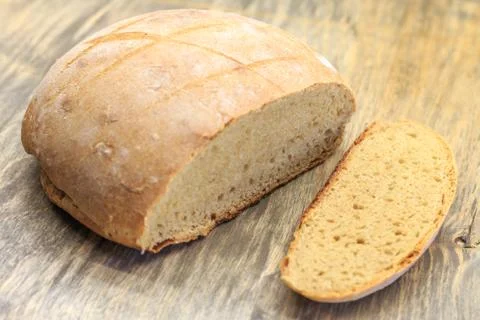 A homemade bread with one slice Stock Photos