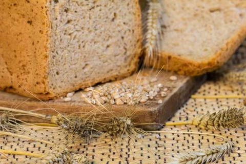 Homemade bread on a rustic scene with wheat Stock Photos