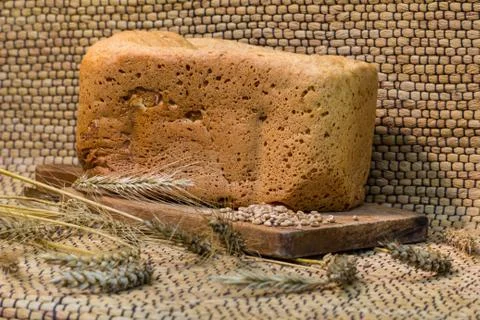 Homemade bread on a rustic scene with wheat Stock Photos