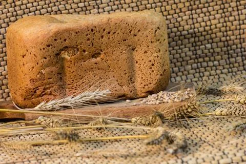 Homemade bread on a rustic scene with wheat Stock Photos