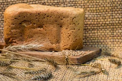 Homemade bread on a rustic scene with wheat Stock Photos