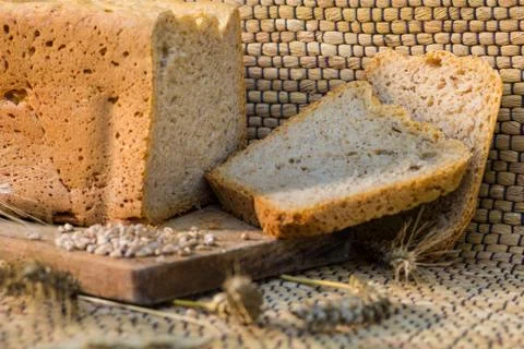 Homemade bread on a rustic scene with wheat Stock Photos