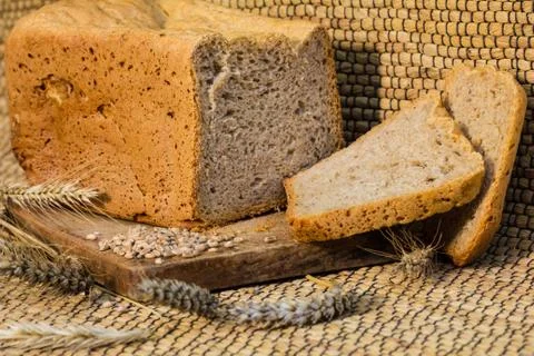 Homemade bread on a rustic scene with wheat Stock Photos