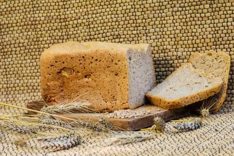 Homemade bread on a rustic scene with wheat Stock Photos