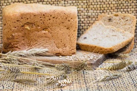 Homemade bread on a rustic scene with wheat Stock Photos