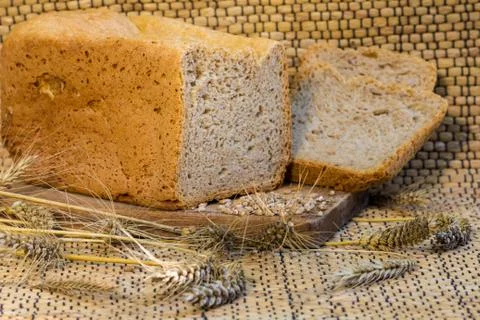 Homemade bread on a rustic scene with wheat Stock Photos