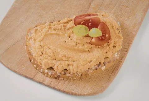 Homemade bread slice with hummus and tomato Stock Photos