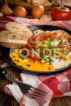 Homemade breakfast fried egg with tomato. Stock Photos