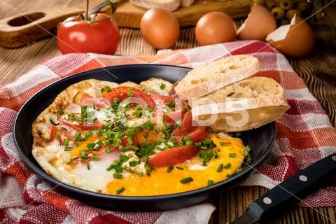 Homemade breakfast fried egg with tomato. Stock Photos