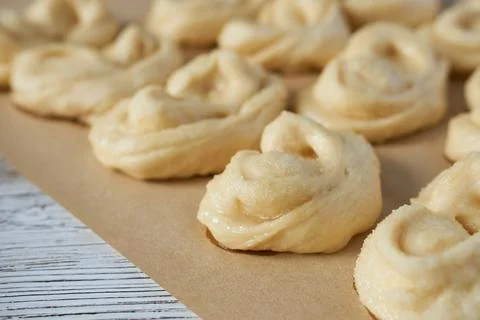 Homemade buns on a baking sheet. Selective focus. Stock Photos
