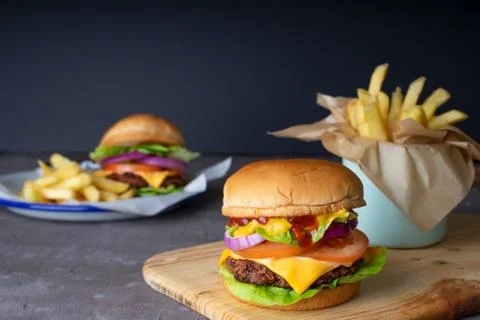 Homemade burger serve with french fries with black background Stock Photos