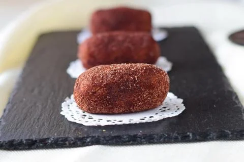 Homemade cake without baking named potato on a black tile. Selective focus. Foto stock