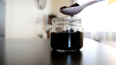 Homemade cherry jam pour into cans Stock Footage 87417534