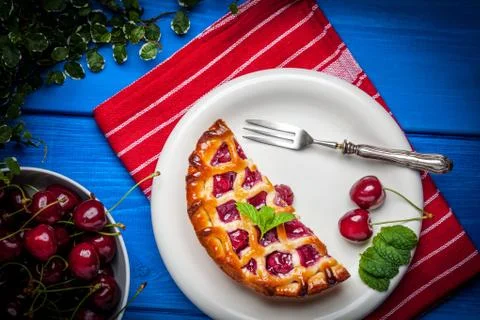 Homemade cherry pie on blue table. Stock Photos