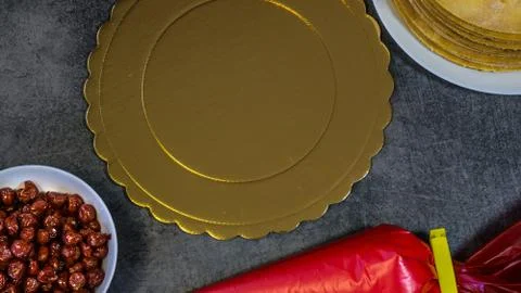 Homemade cherry pie, on a stone table, biscuits, pastry bag with cream, cherr Stock Photos