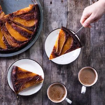 Homemade chocolate cake with pears in rustic style - sweet food concept Stock Photos