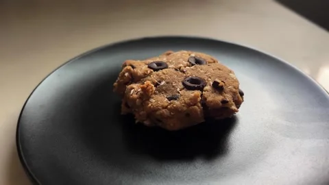 Homemade Chocolate Chip Cookie on Matte Black Plate Stock Footage 334593708