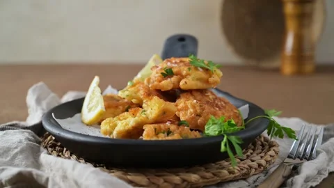 Homemade cod fish fritters served in a black skillet 動画素材 338365543
