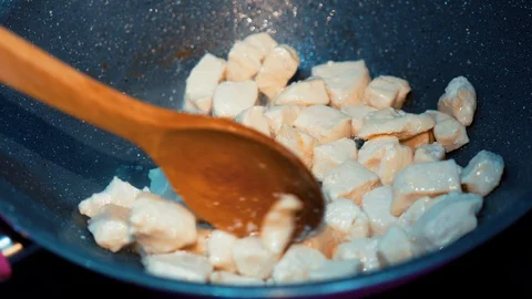 Homemade cooking sauteed chicken breast in frying pan Stock Footage 128752553